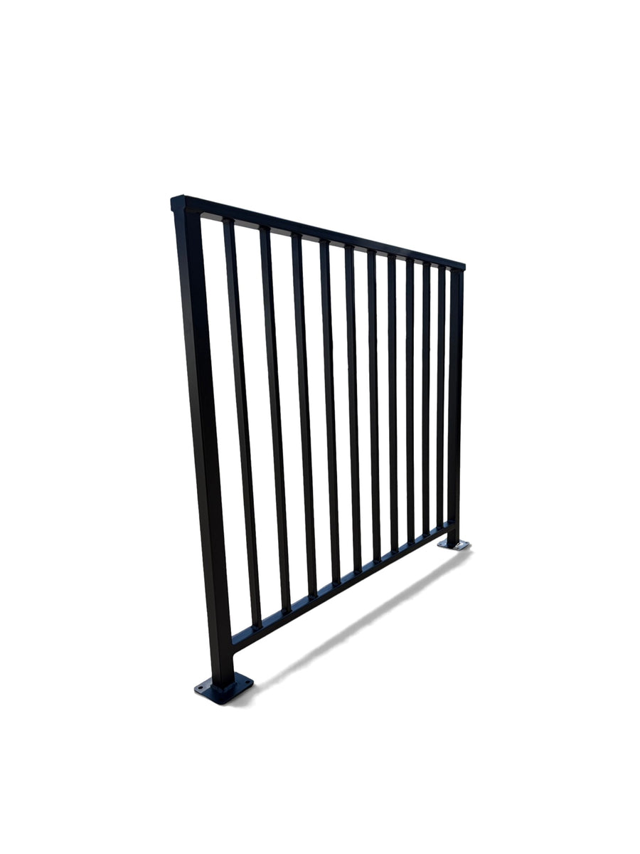 Axis vertical bar steel railing panel at an angle — matte black powder coated guardrail showing post depth and flat cap rail, custom made to size
