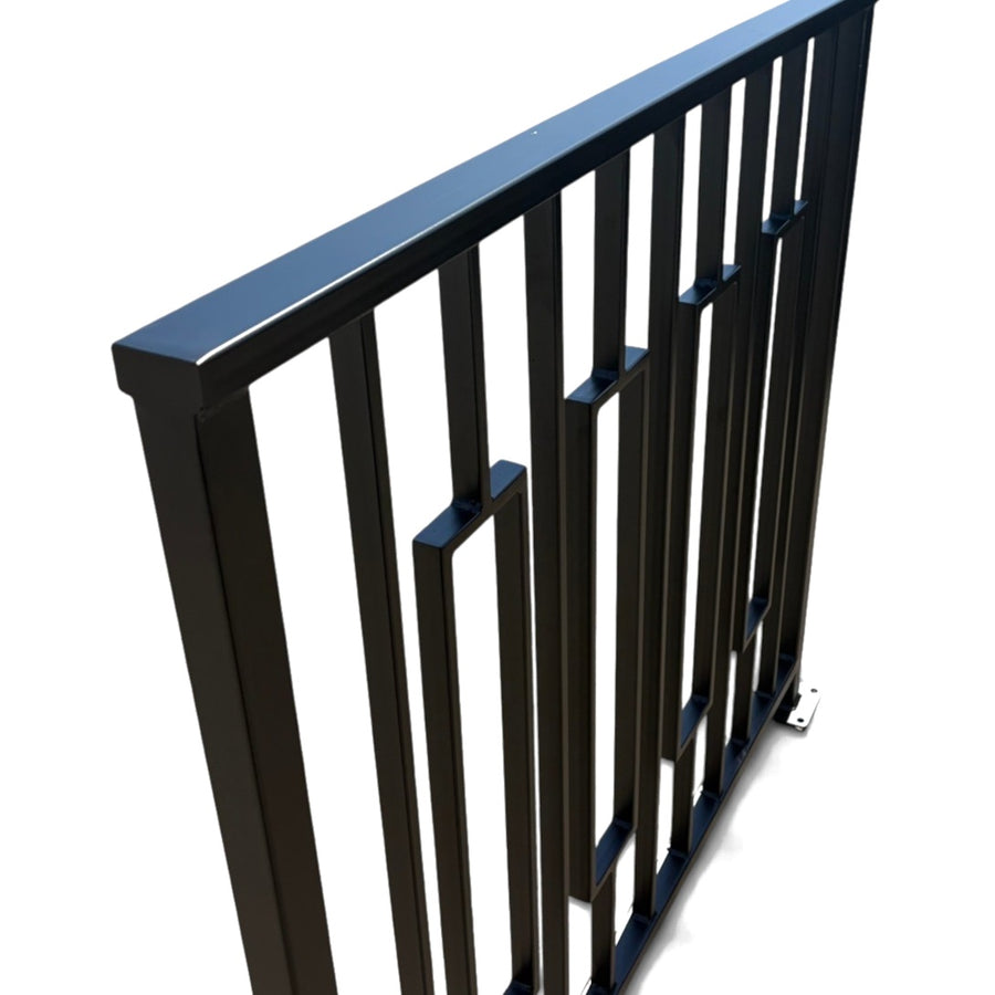 Close view of the Keystone railing corner — cap rail, vertical bars and the offset frame detail in welded steel