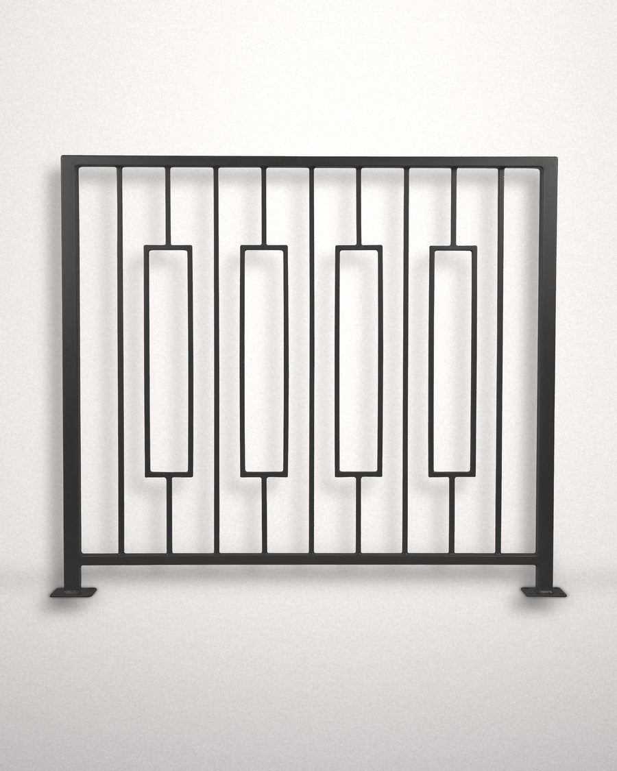 Keystone framed railing panel in matte black powder coated steel standing against a plain wall — four floating rectangular frames between vertical bars, custom welded guardrail made to size in New Jersey