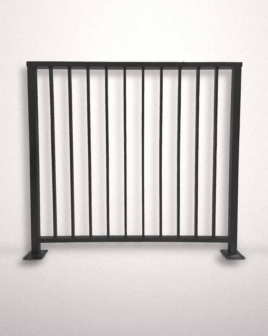 Axis vertical bar railing panel, front view against a plain wall — matte black powder coated steel, welded to size in New Jersey