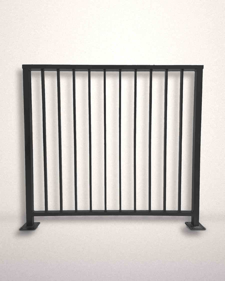Axis vertical bar railing panel, full length view — matte black powder coated steel guardrail with bolt-down base plates