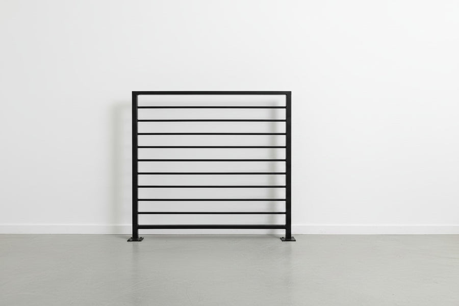 Horizon horizontal bar railing panel in matte black powder coated steel — welded guardrail with evenly spaced horizontal bars and bolt-down base plates, custom made to size in New Jersey