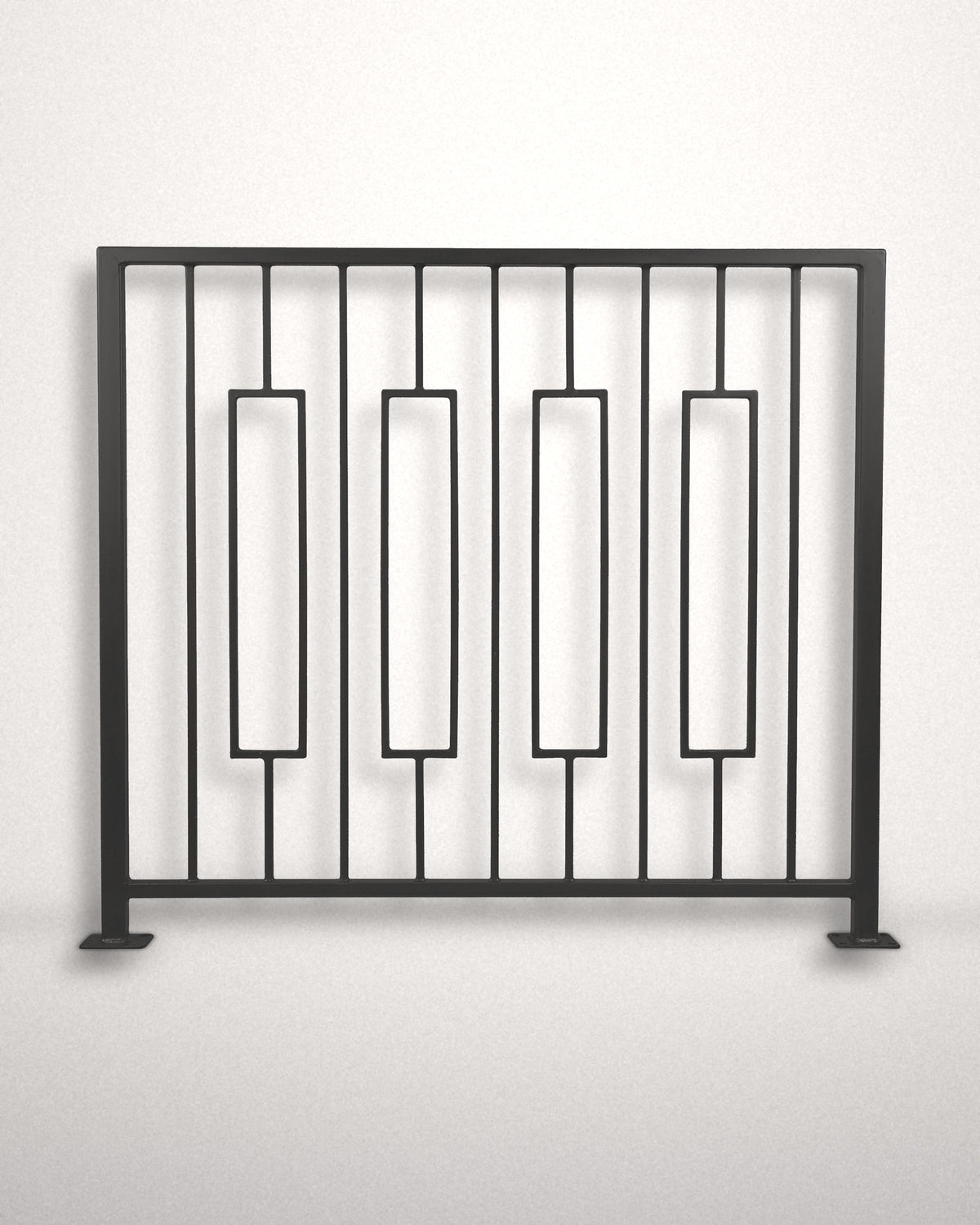 Keystone framed railing panel in matte black powder coated steel standing against a plain wall — four floating rectangular frames between vertical bars, custom welded guardrail made to size in New Jersey