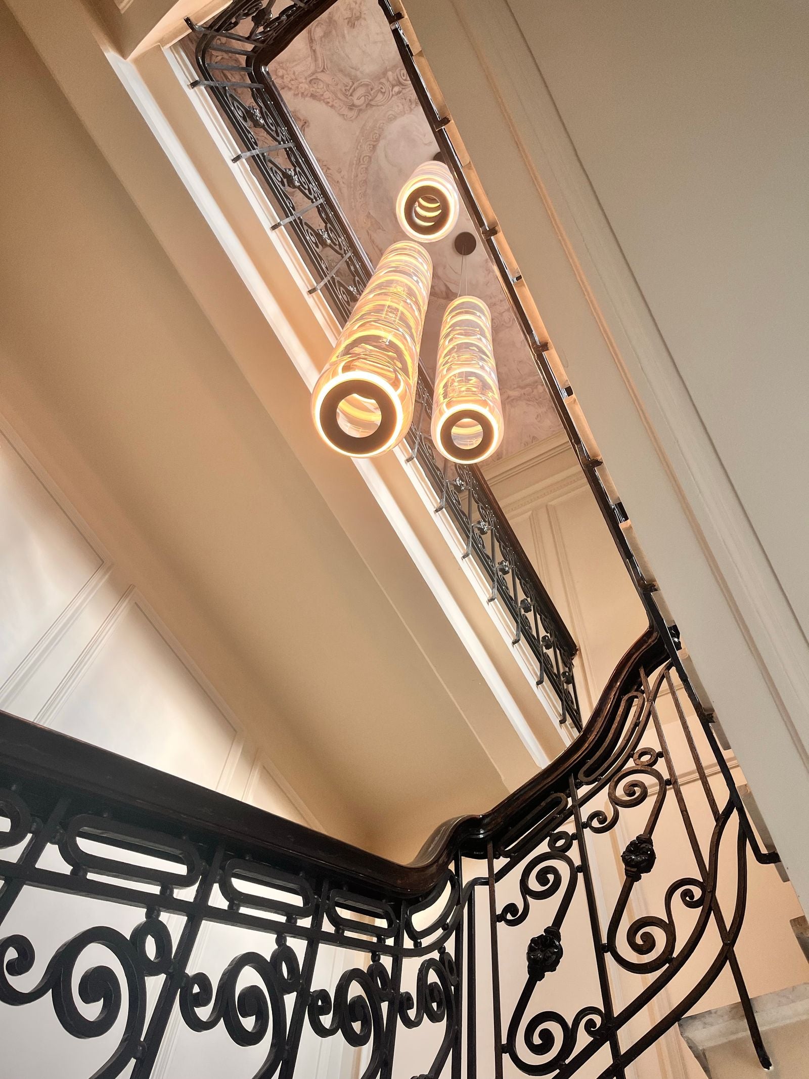 Black iron railings in a luxury home with designer lighting